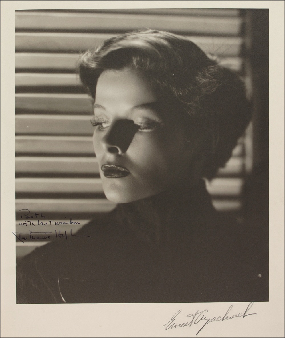 Lot 1054 Katharine Hepburn: Signing a superb early Bachrach photo