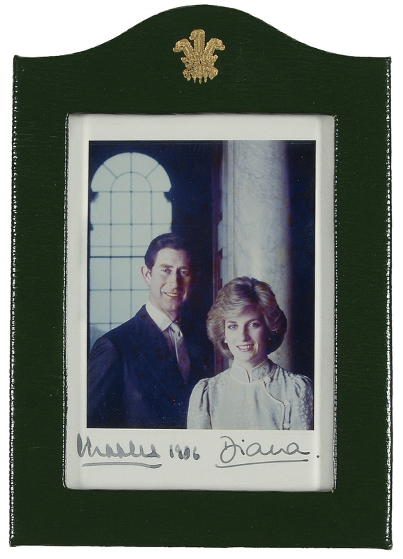 Lot 167 Charles and Diana: O CANADA: CHARLES and DIANA sign a photo for the flight navigator for their 1986 visit to Canada