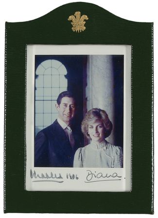 Lot #167 Charles and Diana: O CANADA: CHARLES and DIANA sign a photo for the flight navigator for their 1986 visit to Canada - Image 1