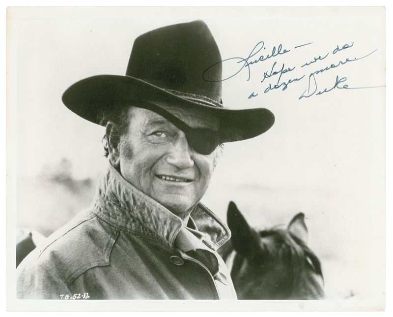 Lot 1054 John Wayne: The Duke signs a True Grit photo for a stunt woman