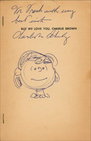 Lot #686 Charles Schulz: Schulz signs a Peanuts book adding a scarce sketch of Lucy - Image 1