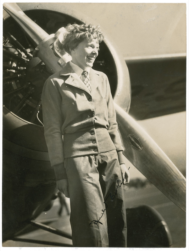 Lot 457 Amelia Earhart: Earhart standing before the Lockheed Vega that carried her across the Atlantic