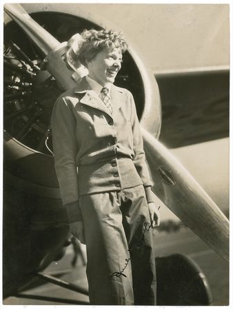 Lot #457 Amelia Earhart: Earhart standing before the Lockheed Vega that carried her across the Atlantic - Image 1