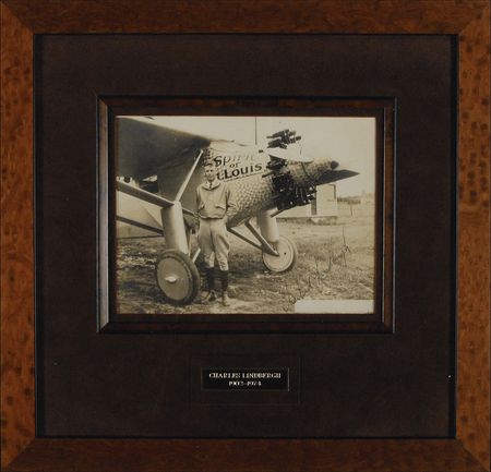 Lot #397 Charles Lindbergh: Lindbergh poses proudly with the Spirit of St. Louis - Image 1
