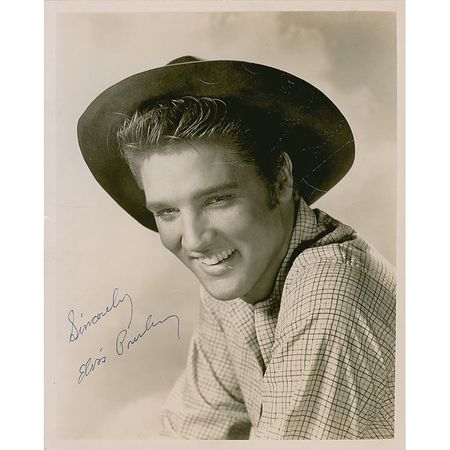 Lot #998 Elvis Presley: Elvis signs for the daughters of a policeman providing security in St. Louis in 1957 - Image 1