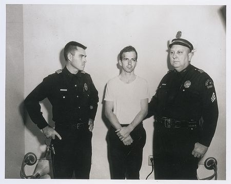 Lot #223 Lee Harvey Oswald Photos in Custody and Holding Rifle - Image 1