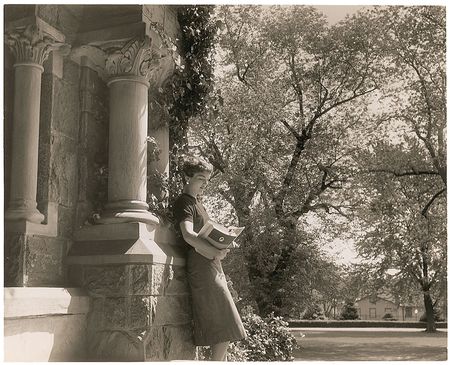 Lot #109 Jacqueline Kennedy Photograph Glancing Through Her Textbooks - Image 1