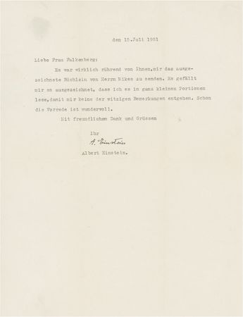 Lot #215 Albert Einstein: The 72-year-old Princeton professor enjoys a new book from the wife of filmmaker Paul Victor Falkenberg - Image 1