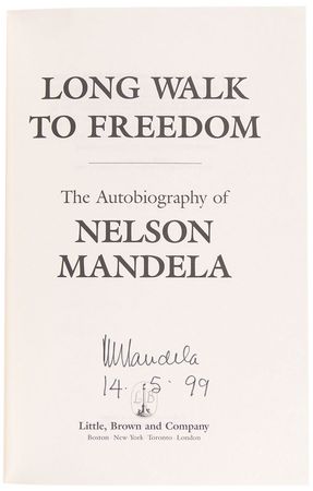 Lot #231 Nelson Mandela: President Mandela signs his autobiography, with provenance directly from his office - Image 1