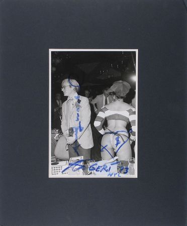 Lot #664 Andy Warhol: Warhol caught in a compromising position at a party, adding an apropos heart and dollar-sign sketch - Image 2