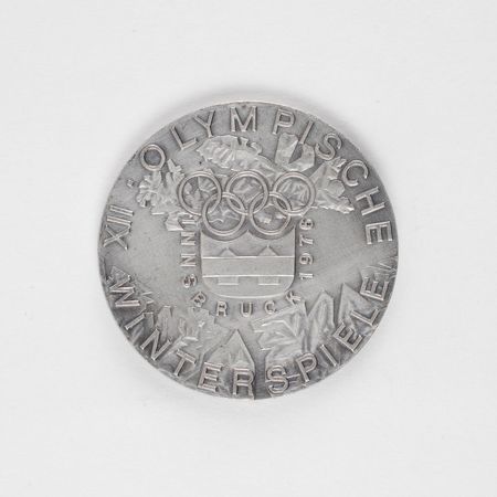 Lot #9117 Innsbruck 1976 Winter Olympics Silvered Bronze Participation Medal - Image 1