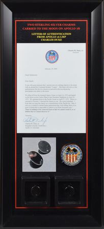 Lot #8085  Apollo 16 Pair of Charms Flown to Moon By Charlie Duke - Image 1