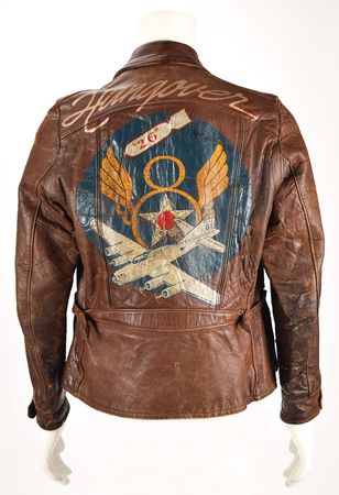 Lot #328 WWII: Spencer H. Scherer's B-17 'Hangover' 369th Bomb Squadron Flight Jacket: Extraordinary hand-painted ?Fightin? Bitin?? 8th Air Force jacket, with a piece of flak that hit the airman's bomber - Image 1