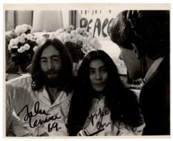 Lot #619 Beatles: John Lennon and Yoko Ono: Rare photo of the Lennons during their 'Bed in for Peace' protests, signed by John while he was still with The Beatles - Image 1