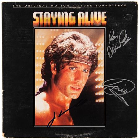 Lot #7323 The Bee Gees and John Travolta Signed Album - Staying Alive - Image 1