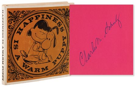 Lot #534 Charles Schulz Signed Book - Happiness Is a Warm Puppy - Image 1