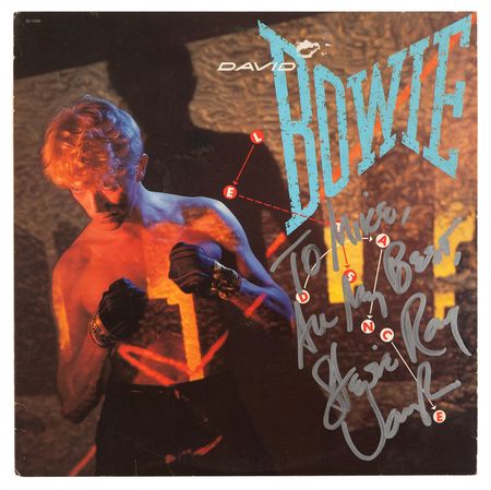 Lot #9413 Stevie Ray Vaughan Signed Album - Let's Dance by David Bowie - Image 1
