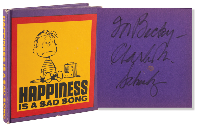 Lot 543 Charles Schulz Signed Book - Happiness Is a Sad Song