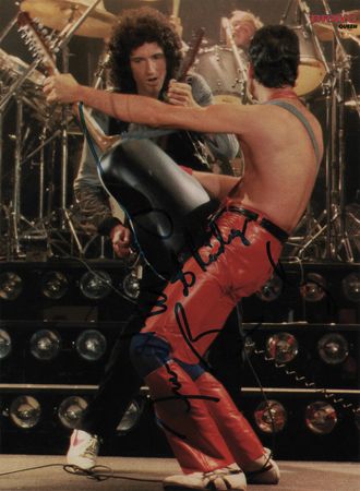 Lot #801 Queen: Freddie Mercury and Brian May Signed Magazine Page - Image 1