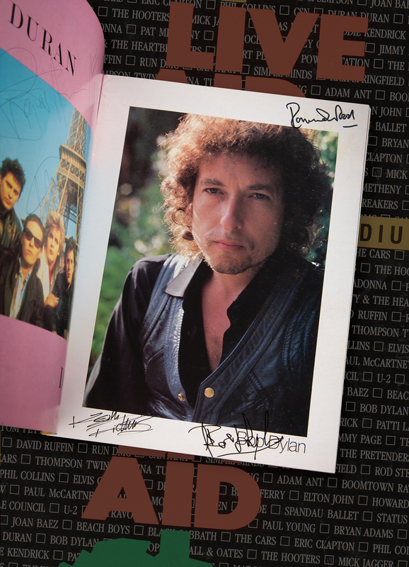 Lot 675 Live Aid USA Multi-Signed (75+) Program with Bob Dylan, Led Zeppelin, Rolling Stones, Black Sabbath, Eric Clapton, Madonna, Tom Petty, and More
