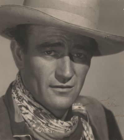 Lot #597. John Wayne Signed Oversized Photograph