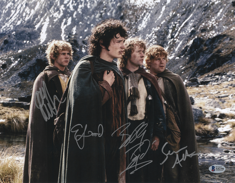 Lot 598 Lord of the Rings Multi-Signed Oversized Photograph - Elijah Wood, Sean Astin, Dominic Monaghan, and Billy Boyd