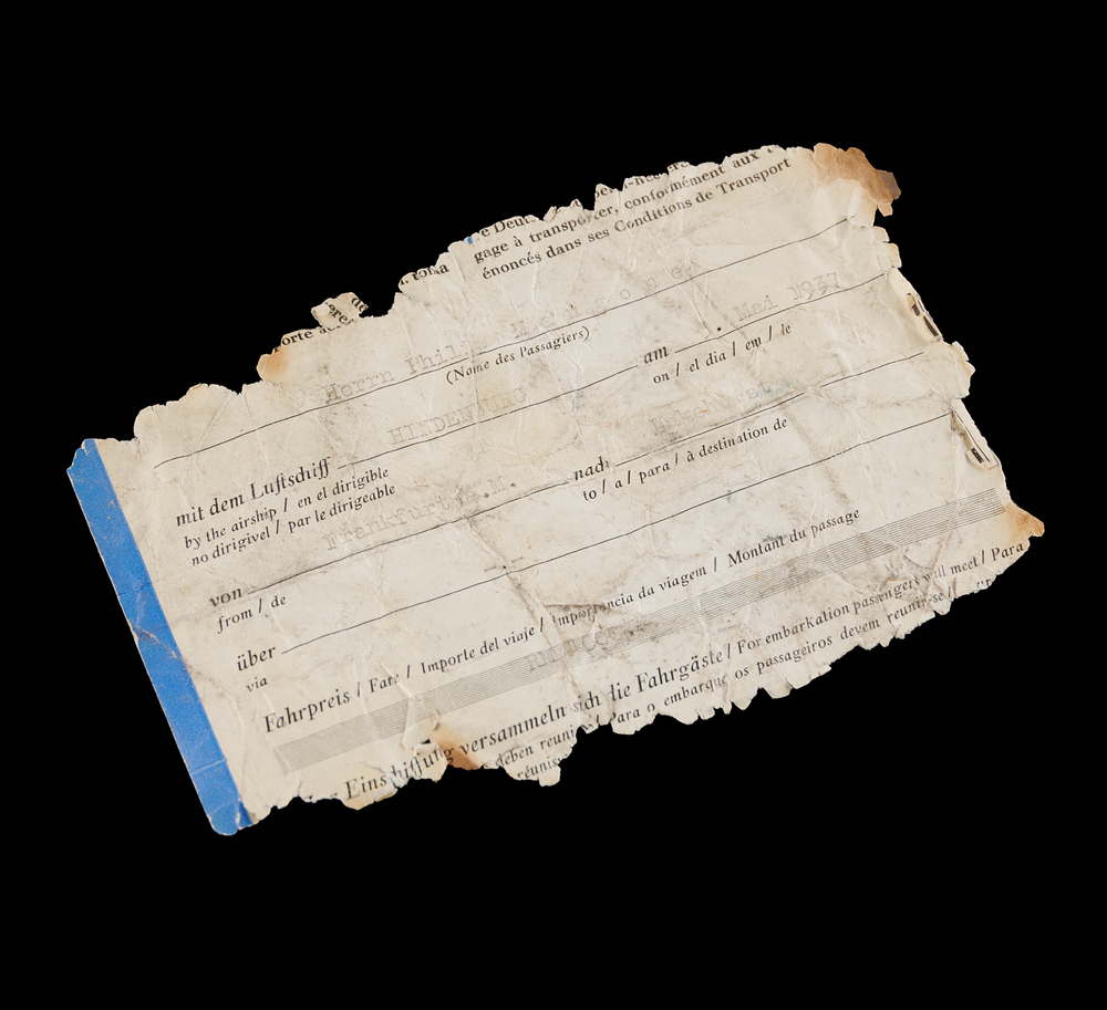 Lot 7015 Hindenburg Disaster: Original Ticket, Radiogram, Wine Menu, and Zeppelin China Fragment Recovered from Wreckage